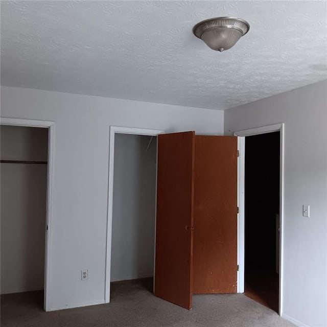 unfurnished bedroom with carpet floors and a textured ceiling