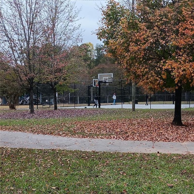 view of sport court featuring a yard