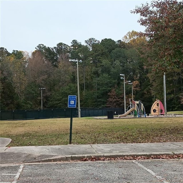 view of property's community featuring a yard and a playground