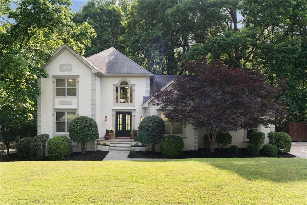 3390 River Ferry Dr, Alpharetta, GA 30022 - view of front of house with french doors, a front yard, stucco siding, and a shingled roof