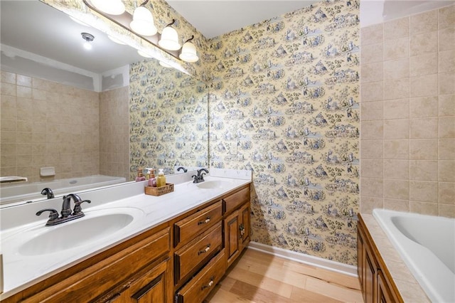 294 Hillcrest Hts, Cornelia, GA 30531 - full bath with baseboards, wallpapered walls, wood finished floors, a bath, and double vanity