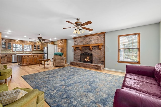 294 Hillcrest Hts, Cornelia, GA 30531 - living room with ceiling fan, light wood finished floors, a fireplace, recessed lighting, and baseboards