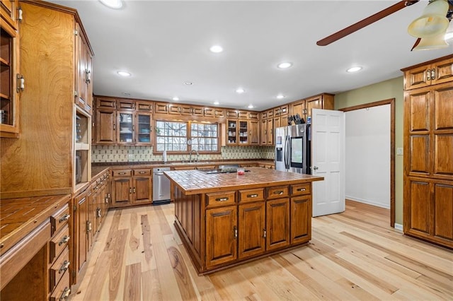 294 Hillcrest Hts, Cornelia, GA 30531 - kitchen with brown cabinetry, light wood-style flooring, stainless steel fridge with ice dispenser, a center island, and recessed lighting