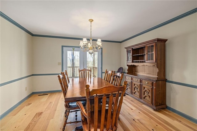 294 Hillcrest Hts, Cornelia, GA 30531 - dining area with a chandelier, light wood-style floors, baseboards, and crown molding
