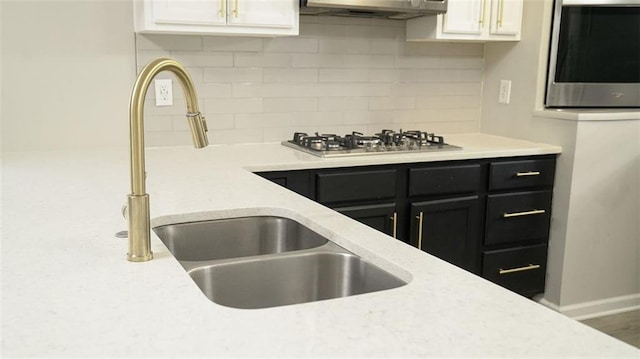 623 Shadowmoore Dr, Riverdale, GA 30274 - kitchen with stainless steel appliances, dark cabinets, decorative backsplash, and white cabinets