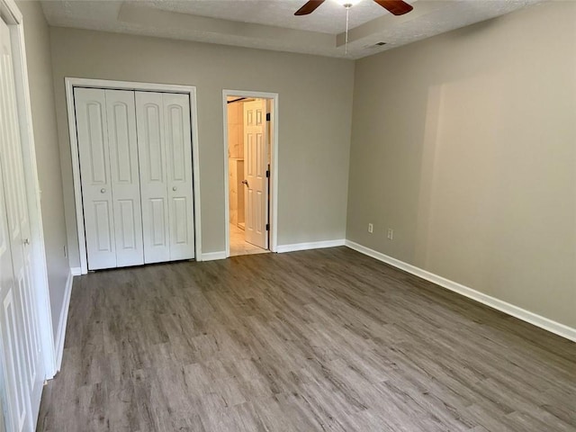 623 Shadowmoore Dr, Riverdale, GA 30274 - unfurnished bedroom with wood finished floors, a closet, ceiling fan, and ensuite bath