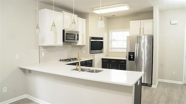 623 Shadowmoore Dr, Riverdale, GA 30274 - kitchen featuring stainless steel appliances, a peninsula, light countertops, and backsplash