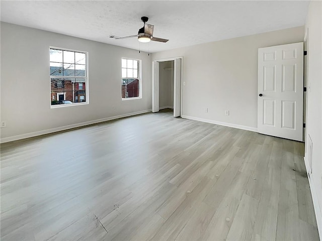 unfurnished bedroom featuring ceiling fan, light hardwood / wood-style floors, and a textured ceiling