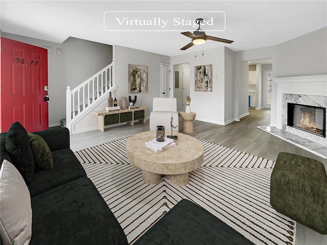 living room with a fireplace, hardwood / wood-style floors, and ceiling fan