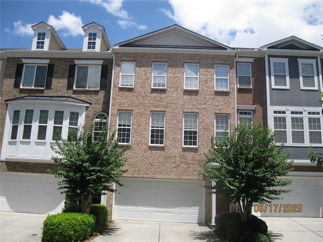 2975 Wintercrest Trce, Dunwoody, GA 30360 - view of property with an attached garage, concrete driveway, and brick siding