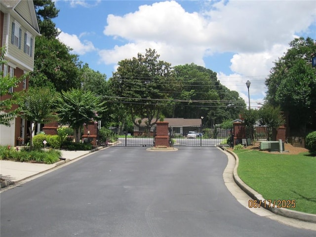 2975 Wintercrest Trce, Dunwoody, GA 30360 - view of asphalt street featuring a gate, curbs, street lighting, and a gated entry