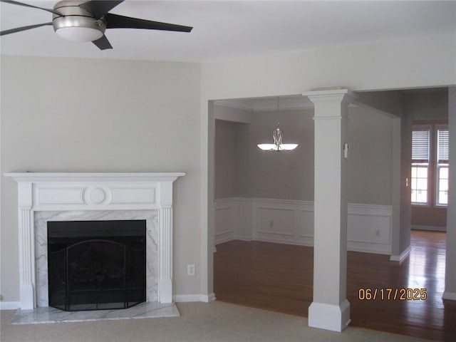 2975 Wintercrest Trce, Dunwoody, GA 30360 - unfurnished living room with a ceiling fan, a chandelier, a wainscoted wall, wood finished floors, and a premium fireplace