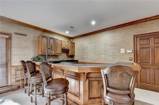 bar with light colored carpet, ornamental molding, and sink