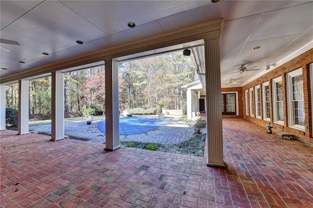 view of patio / terrace with ceiling fan and a covered pool