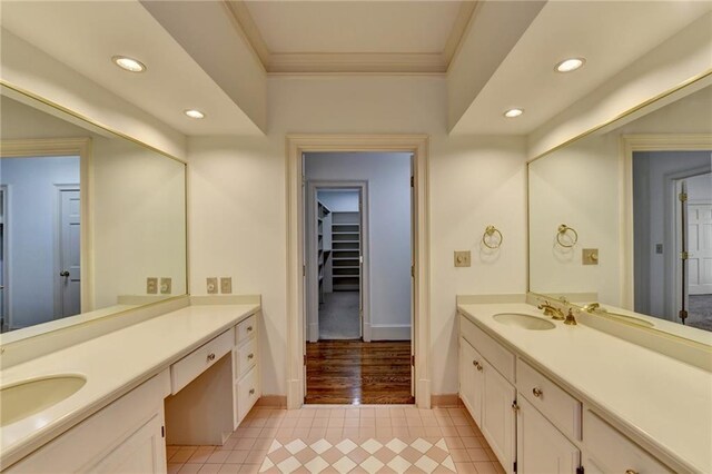 bathroom with crown molding, tile patterned flooring, and vanity