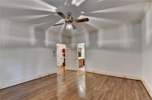 empty room with hardwood / wood-style flooring, ceiling fan, and ornamental molding