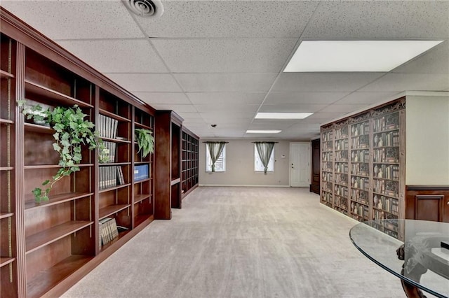 basement with a drop ceiling and carpet floors