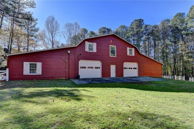 view of side of property with a yard and an outdoor structure