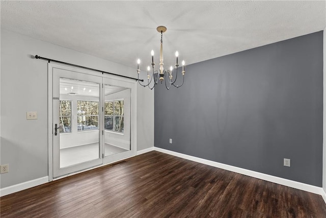 unfurnished dining area featuring hardwood / wood-style floors and a chandelier