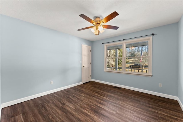 empty room featuring ceiling fan and dark hardwood / wood-style floors