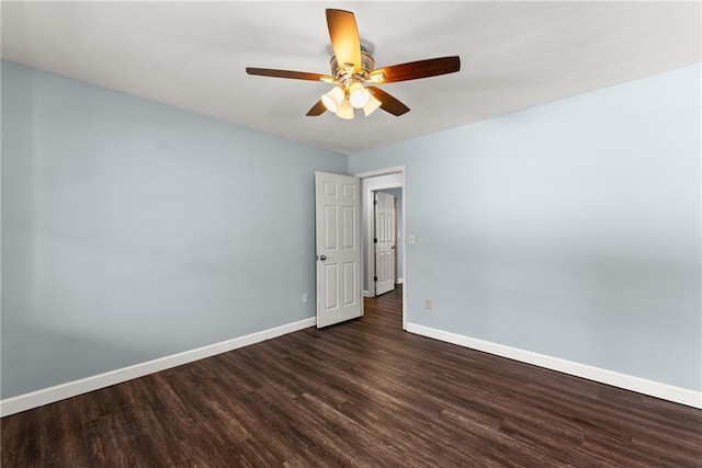 unfurnished room with ceiling fan and dark wood-type flooring