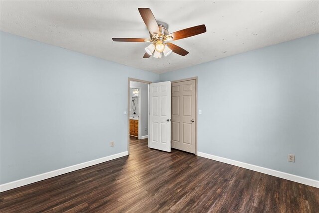 empty room featuring ceiling fan and dark hardwood / wood-style floors