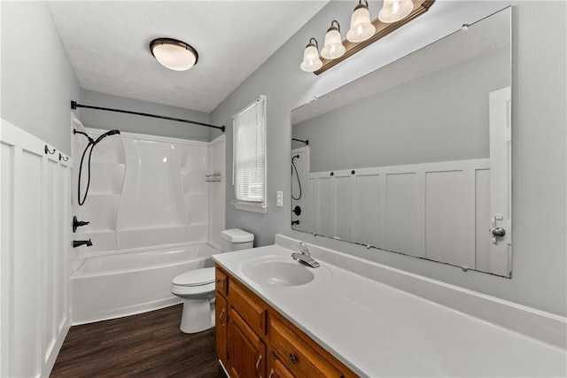 full bathroom featuring bathing tub / shower combination, hardwood / wood-style floors, vanity, and toilet