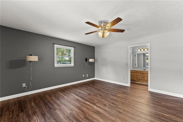 spare room featuring ceiling fan and dark hardwood / wood-style floors