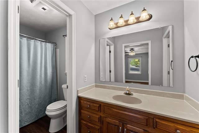 bathroom featuring toilet, hardwood / wood-style floors, ceiling fan, a shower with shower curtain, and vanity