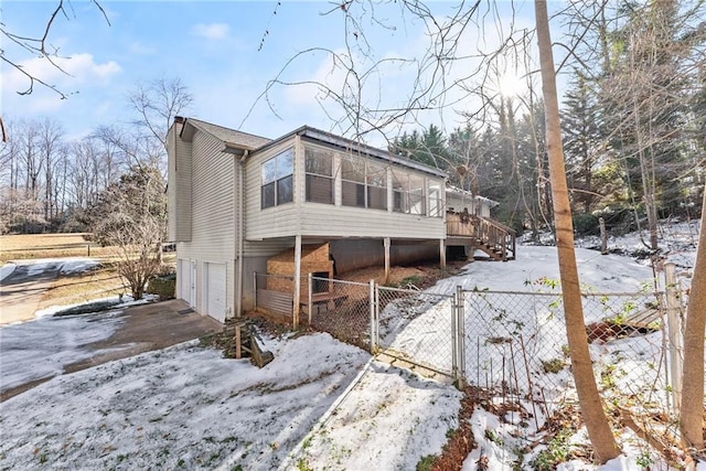 exterior space with a garage and a wooden deck