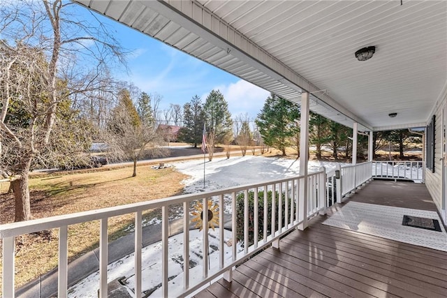 wooden terrace featuring covered porch