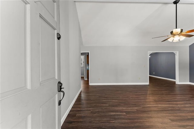 interior space featuring lofted ceiling, ceiling fan, and dark wood-type flooring