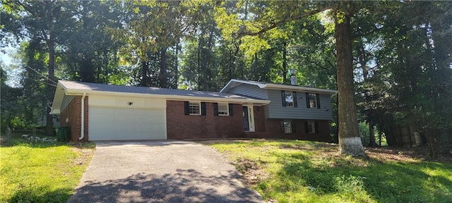 tri-level home featuring a garage and a front yard