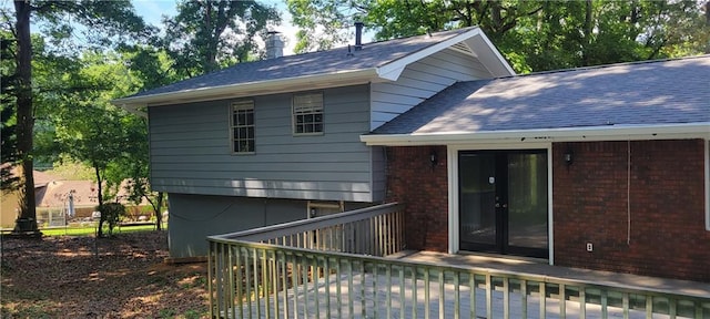 rear view of house with a wooden deck and french doors