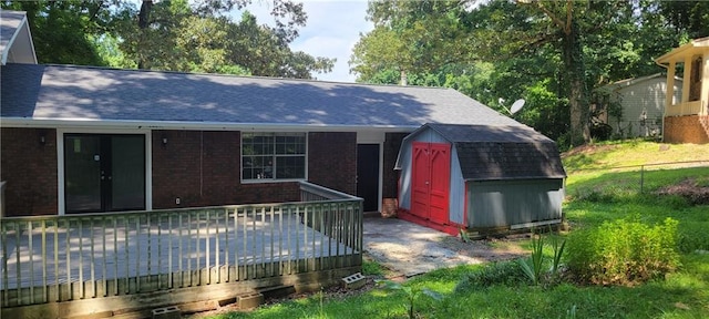 exterior space featuring a storage unit and a wooden deck