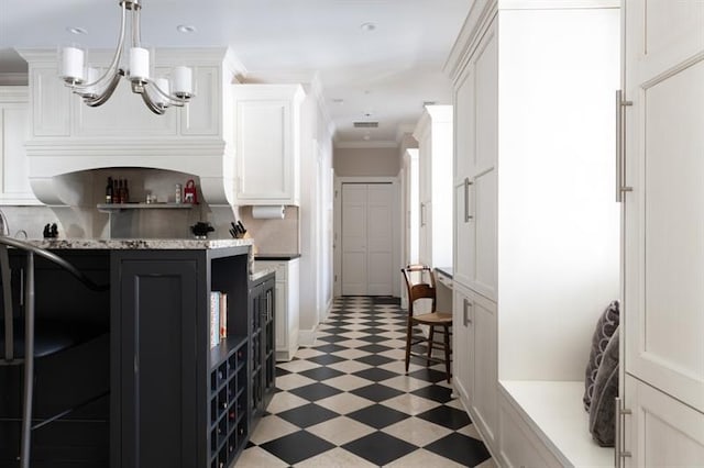 kitchen featuring light floors, open shelves, ornamental molding, white cabinets, and a chandelier