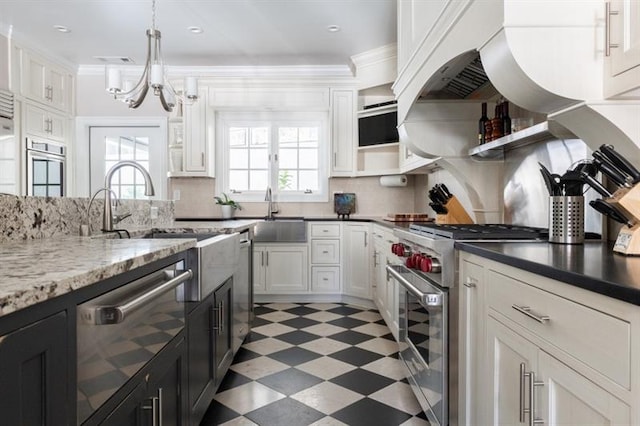 kitchen with light floors, open shelves, a sink, appliances with stainless steel finishes, and a chandelier