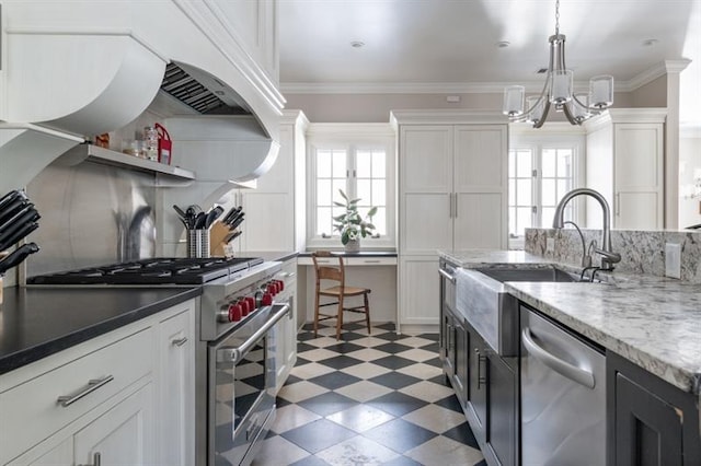 kitchen featuring a wealth of natural light, light floors, appliances with stainless steel finishes, and a chandelier