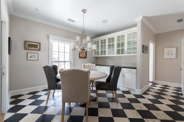 dining room featuring a notable chandelier, light floors, and crown molding