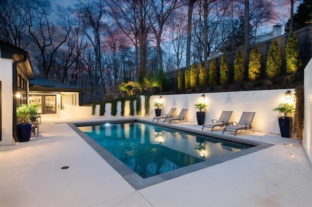 view of pool with a fenced in pool, a patio, and fence