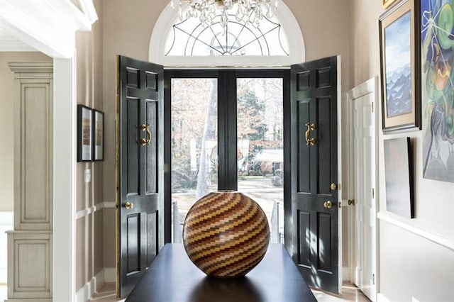 foyer entrance with a chandelier