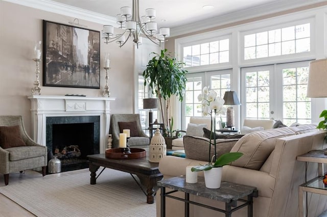 living room featuring a fireplace with flush hearth, a chandelier, and crown molding