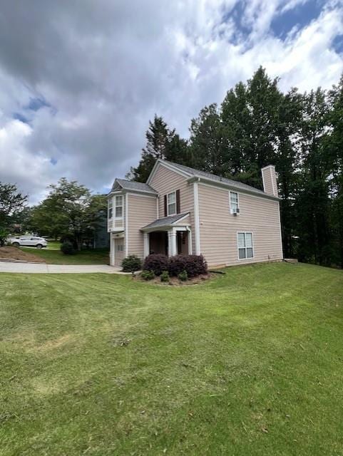 5030 N Bridges Dr, Alpharetta, GA 30022 - view of property exterior with a chimney, a garage, concrete driveway, and a yard