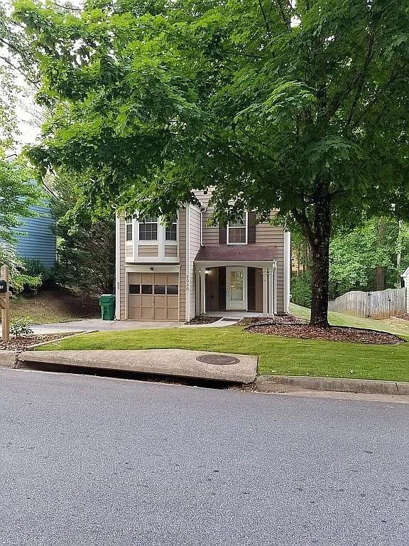 5030 N Bridges Dr, Alpharetta, GA 30022 - view of front of house featuring an attached garage and asphalt driveway