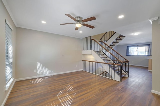 spare room featuring ornamental molding, dark wood-type flooring, and ceiling fan