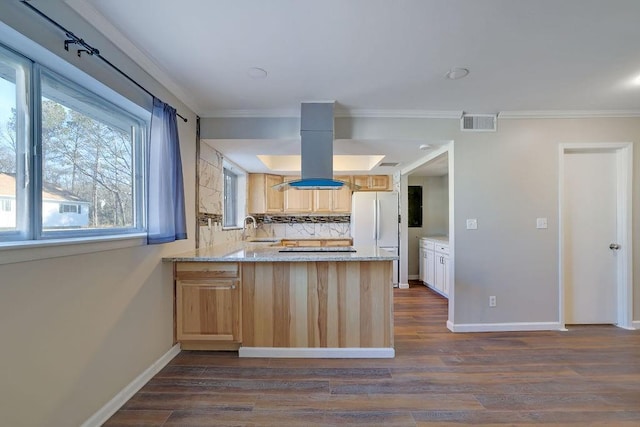 kitchen with white refrigerator, sink, light brown cabinets, kitchen peninsula, and dark hardwood / wood-style floors