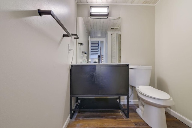 bathroom with toilet and hardwood / wood-style floors