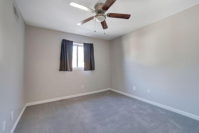 carpeted spare room featuring ceiling fan