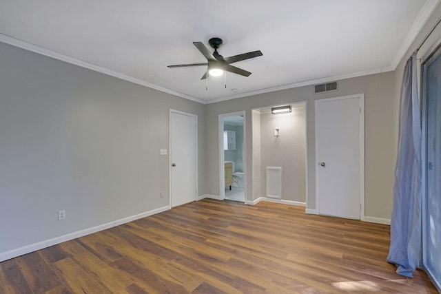 unfurnished bedroom with dark hardwood / wood-style flooring, ensuite bath, ceiling fan, and crown molding