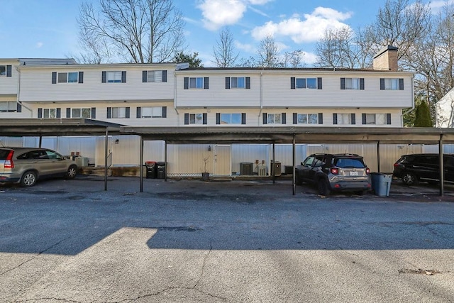 view of parking / parking lot featuring a carport